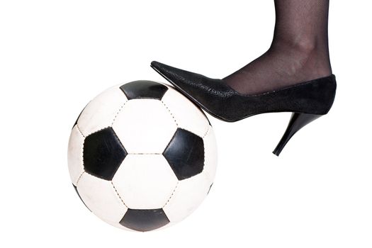 Foot on black white football or soccer sport ball