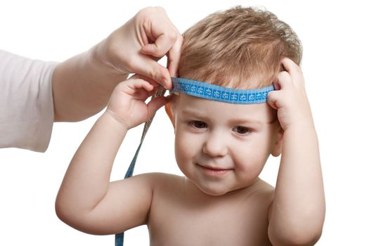 Measure tape in hand measuring child head isolated