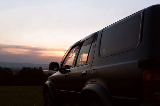 Off-road car in the background of the sunset