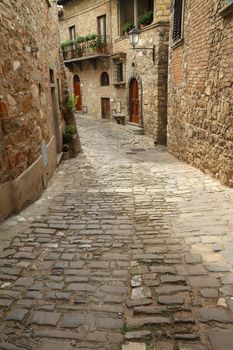 narrow stony street in italian medieval village Montefioralle,Tuscany, Europe