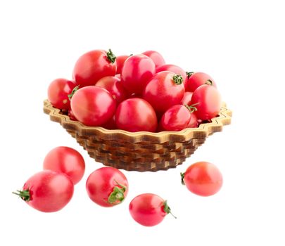 red small tomatos in dish and spilled on white isolated