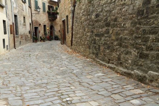 stony antique narrow street in tuscan village Montefioralle, Italy, Europe