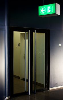 Emergency exit sign in modern offices inside an industrial plant