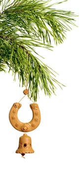 souvenir horseshoe with bell hangs on fir branch