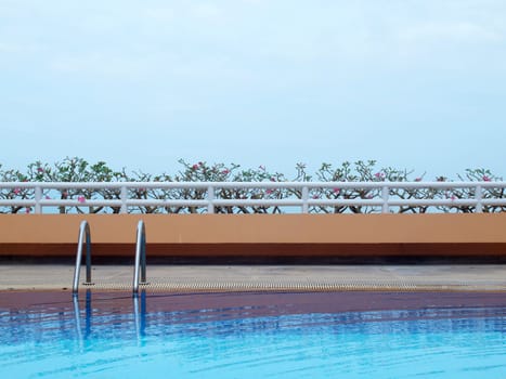 Swimming pool with blue water on terrace of condominium