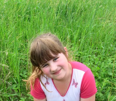 portrait of girl on green grass background