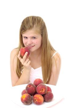 young  woman holds peach in hand on white