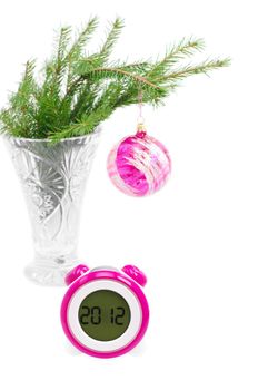 the clock shows 2012 on the face. fir twig in vase back