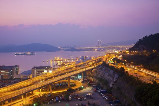 Tsing Ma Bridge and highway at sunset, show the modern landscape of Hong Kong. 