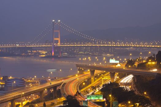 Tsing Ma Bridge and highway at sunset, show the modern landscape of Hong Kong.