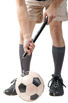 Foot on black white football or soccer sport ball