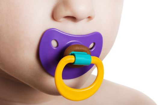 Little child boy and plastic baby soother pacifier