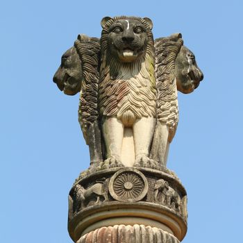 sculpture of emblem of India, four lions (one hidden from view) - symbolizing power, courage, pride and confidence - rest on a circular abacus,park in Malabar Hill, Mumbai