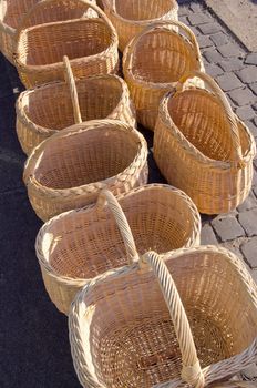 Wicker wooden handmade bags sold at outdoor street market fair