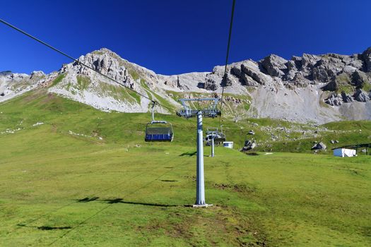summer landscape of Alpine pasture with chairlift