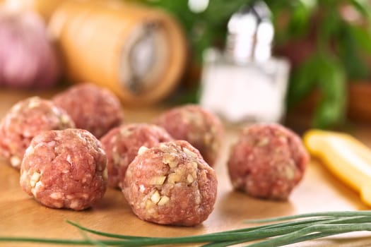 Raw meatballs with garlic (Selective Focus, Focus on the first two meatballs)