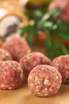 Raw meatballs with garlic (Selective Focus, Focus on the meatball in the front)