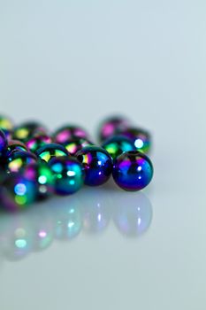 Blue beads on bluish background from right in portrait orientation