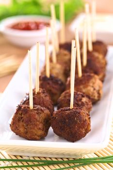 Meatball appetizers with toothpicks (Selective Focus, Focus on the first two meatballs)