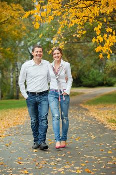 Romantic happy young beautiful couple on autumn walk. Vertical view
