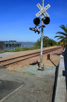 Railroad crossing on a sunny summer day.
