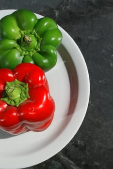 Close up of the red and green bell peppers on a plate.