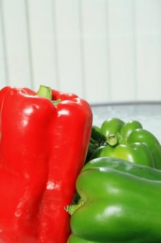 Close up of the red and green bell peppers on a plate.