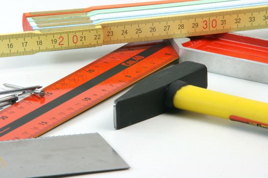 construction concepts carpenter tools meter hammer, nails, angle meter, hand saw closeup