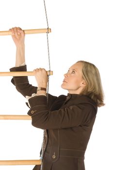 An isolated photo of a businesswoman climbing a rope-ladder