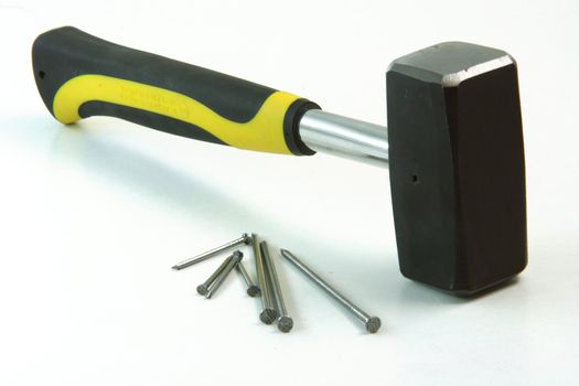 contruction concepts hammer with contruction nails in white background