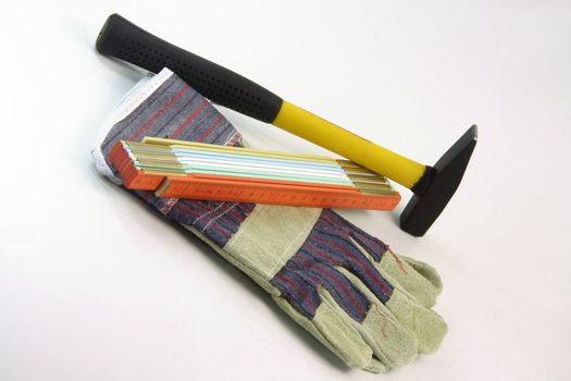 construction tools gloves hammer and meter isolated in white background