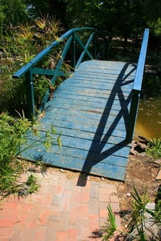 Old wood bridge built over small river.
