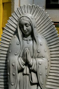 Close up of a statue of a Virgin of Guadalupe.
