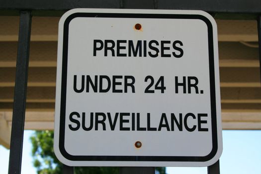 Premises under 24 hour surveillance warning sign.
