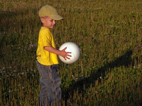 Little child and ball playing soccer sport for fun