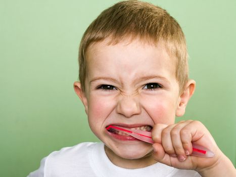 Little child with dental toothbrush brushing teeth