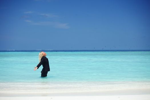 business woman stay in ocean waves