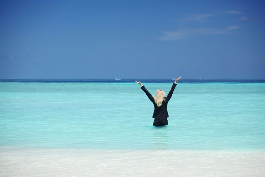 business woman stay in ocean waves