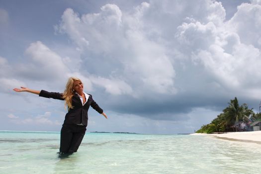 happy  business woman on the desolate ocean coast