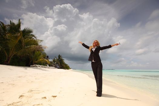 happy  business woman on the desolate ocean coast