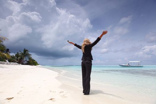 happy  business woman on the desolate ocean coast