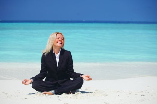 yoga business woman in lotus pose on the beach