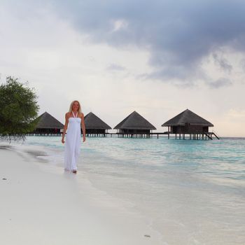 woman in a white dress on the ocean coast