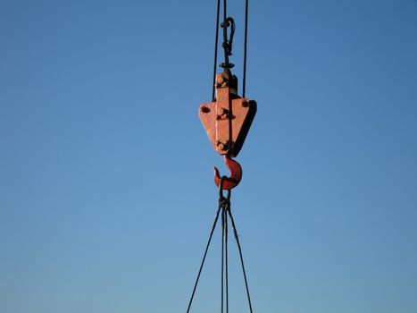 Hook of building crane lifting cargo