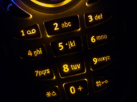 Mobile phone keypad back lit macro image on black