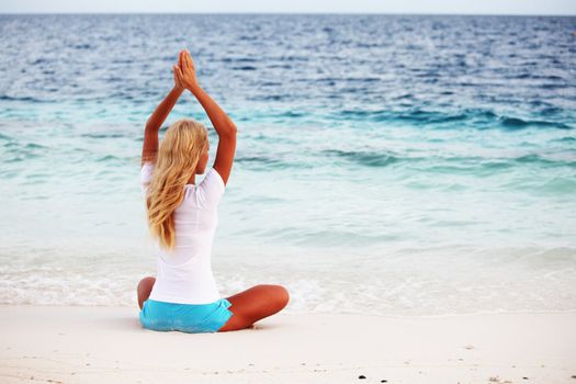 yoga woman on sea coast