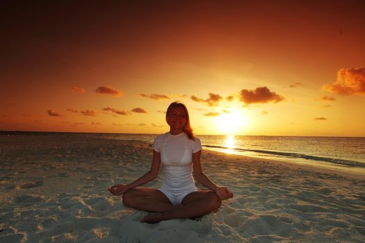 sunset yoga woman on sea coast