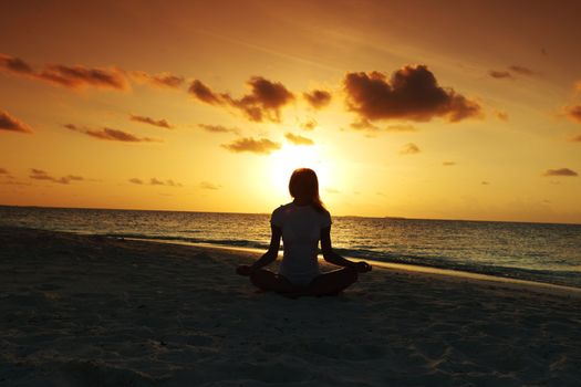 sunset yoga woman on sea coast