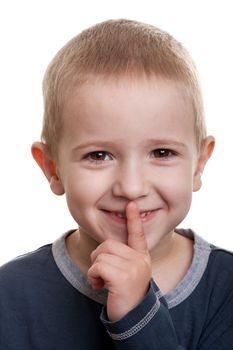 Human child face gesturing finger on lips silence