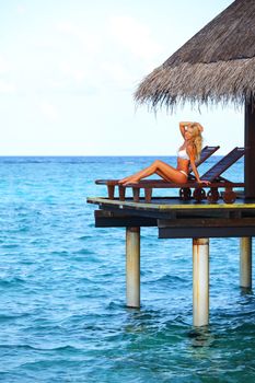 woman on lounge sea on background